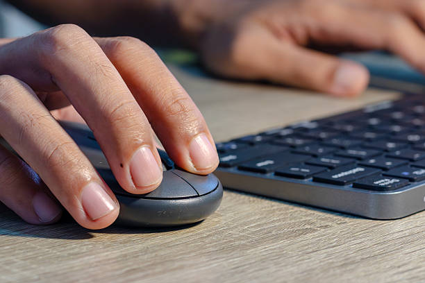 istock Close up view of male hands on computer keyboard and mouse 2242780456