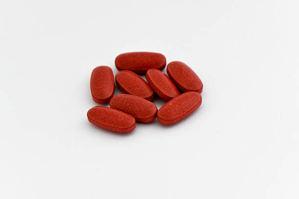 istock Pile of Seven Red Oblong Tablets on a Bright White Background 2242784686