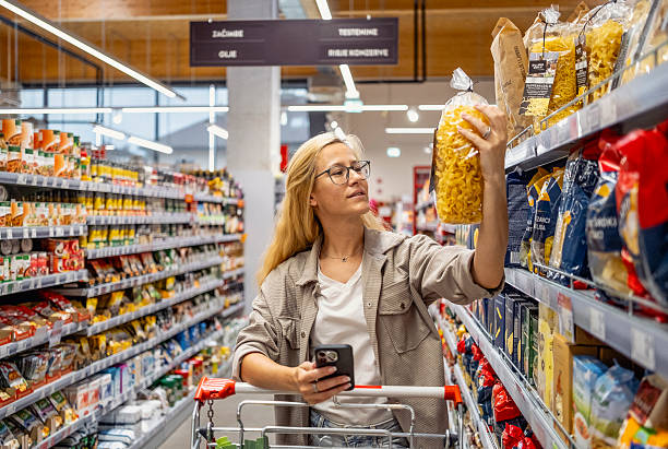 istock Content Shopper Comparing Products in Grocery Store Aisle 2242784922