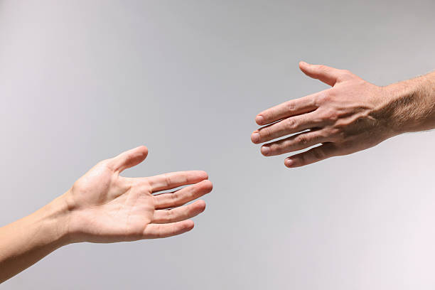 istock Man offering helping hand to his friend on light grey background, closeup 2242784963