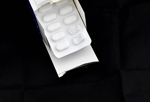 istock Blister Pack of White Pills Emerging from Open Cardboard Box 2242785117