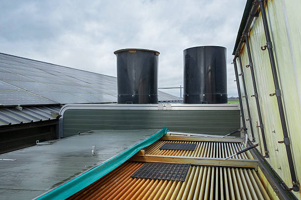 istock Solar panels on top of a chicken barn with a air scrubber. 2242785841