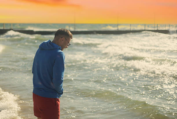 istock A man enjoys the sea at sunset 2242785919