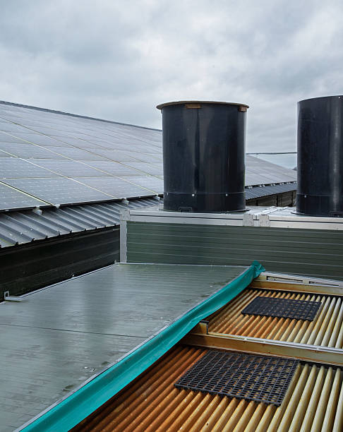 istock Solar panels on top of a chicken barn with a air scrubber. 2242786019