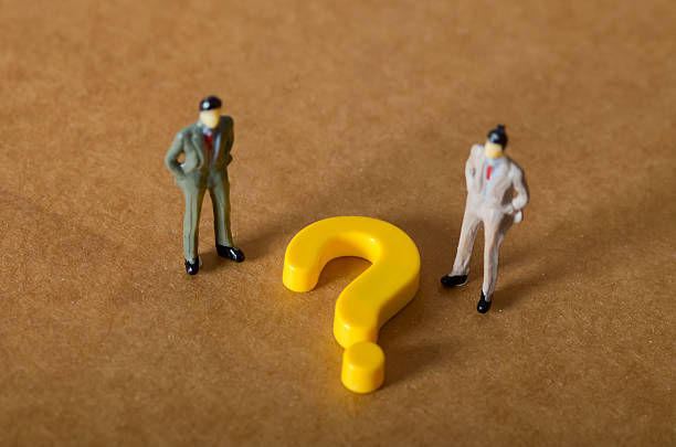 istock Two business figures face a large question mark, symbolizing a critical business decision, strategy dilemma, and the need for professional consultation 2242786692