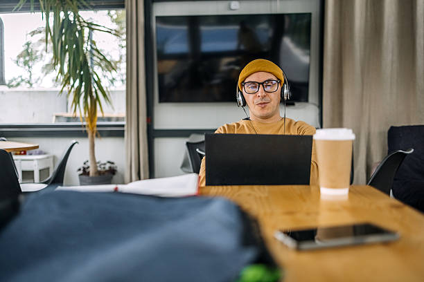 istock Man sitting alone at cafe in front of laptop having online class 2242786864