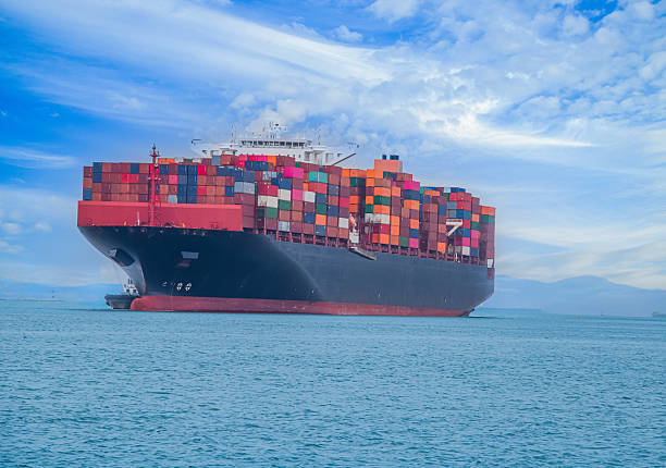 istock Logistics and container loading by large barges by sea in a harbor full of containers waiting to be transported 2242789741