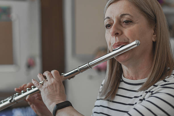 istock Experienced Female Flautist Looking Focused While Performing Classical Music Piece 2242791648