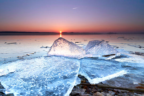 sunrise between the ice on frozen beach in winter