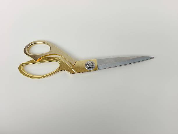 istock Golden-tone scissors with polished blades and ergonomic loop handles, ideal for sewing, crafting and decorative projects. Ideal for product catalogs, lifestyle shoots and premium tool collections 2242797700