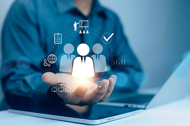 istock Businessman holding digital CRM icon with customer data analytics, teamwork, and business connection symbols, representing customer relationship management and digital marketing strategy. 2242800286