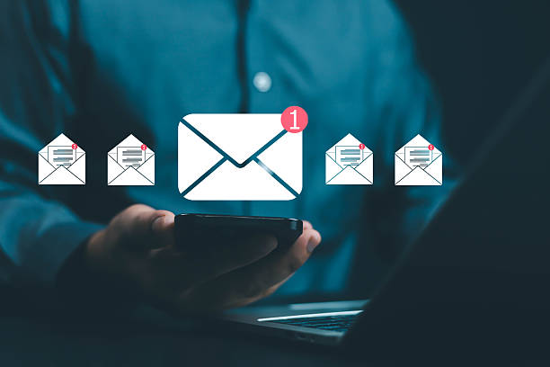 istock Businessman using smartphone with digital email notification icons, representing online communication, message alert, and email marketing in modern business technology and digital networking. 2242800408