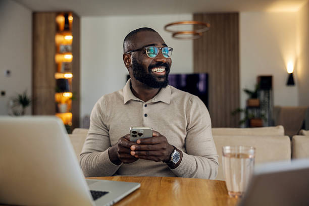 istock African man smiling, celebrating remote work success at home 2242801241
