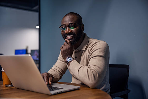 istock Happy man working on laptop in modern office 2242801404