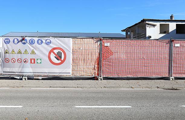 istock Construction fence with information board depicting the warning, prohibition and mandatory signs for building activity 2242803231