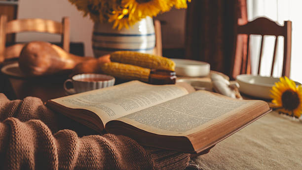 istock Cozy autumn scene with an open book and sunflowers 2242803479