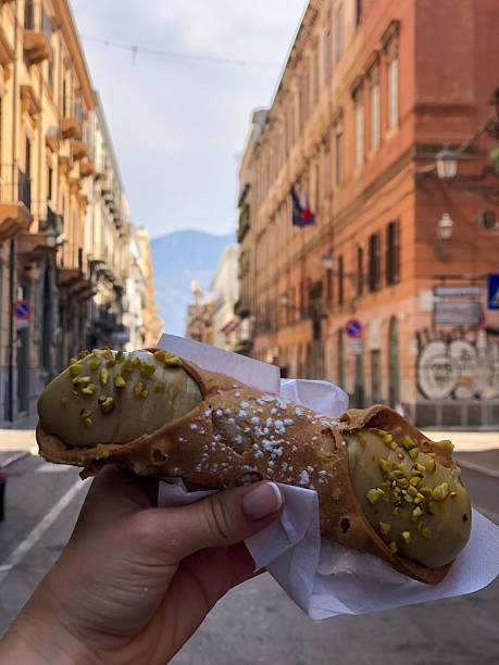 istock Hand Holding Pistachio Cannolo in Palermo, Sicily 2242804911