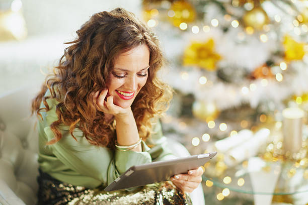 istock Content Woman Engaging with Tablet, Festive Mood 2242809247