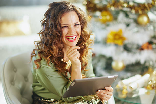 istock Smiling Woman with Tablet, Festive Portrait 2242809749