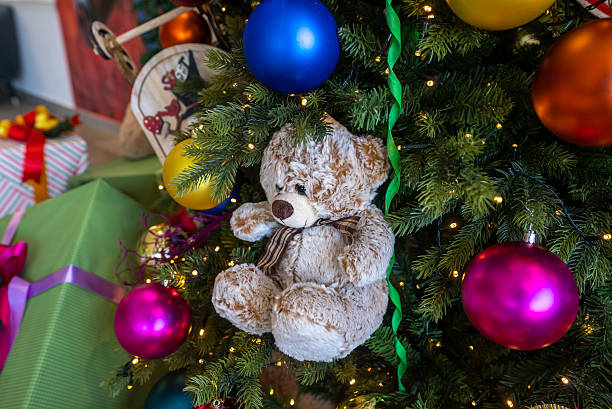 istock Teddy bear ornament hanging on a christmas tree 2242809760