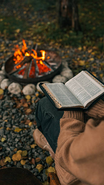 istock Reading the Bible by a Cozy Campfire on a Cool Autumn Day 2242810208