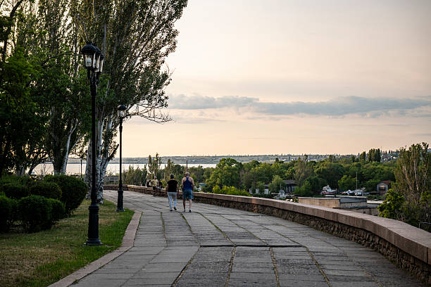 Mykolaiv, Ukraine - June 2, 2025: Two people enjoy a walk on a summer evening in Mykolaiv.