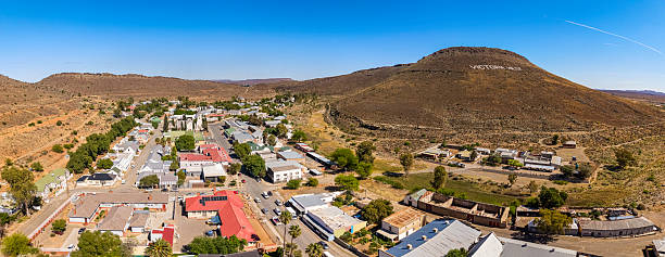 Horizontal lateral view of some children playing in a township graveyard, Willowmore