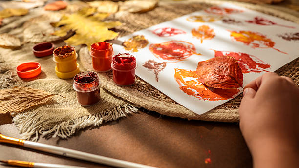istock Autumn leaf art project with paint and brushes 2242811828
