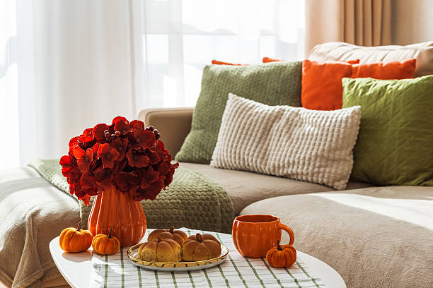 istock Autumn Living Room with Sofa, Pillows and Pumpkin Cinnamon Buns on Coffee Table 2242811895