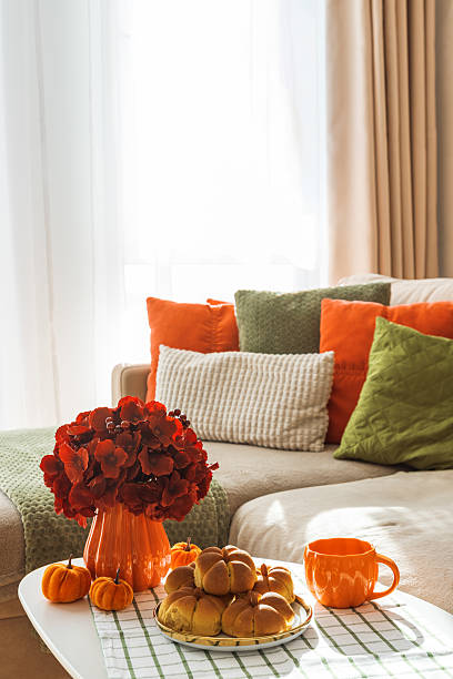 istock Autumn Living Room with Sofa, Pillows and Pumpkin Cinnamon Buns on Coffee Table 2242811910