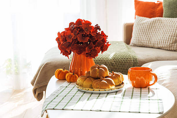 istock Autumn Living Room with Sofa, Pillows and Pumpkin Cinnamon Buns on Coffee Table 2242811931