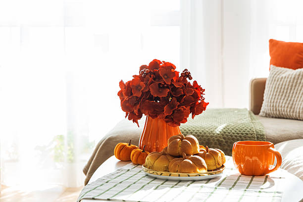 istock Autumn Living Room with Sofa, Pillows and Pumpkin Cinnamon Buns on Coffee Table 2242811945