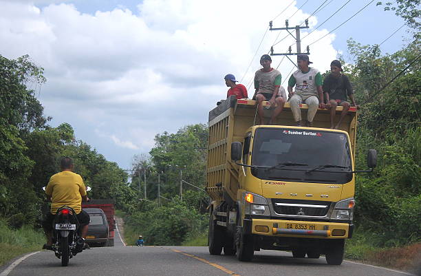 Young and fresh group of friends enjoying a road trip journey and freedom in a country road.Note for inspectors: The car is old and edited and it was already accepted in a previous batch with no issues.