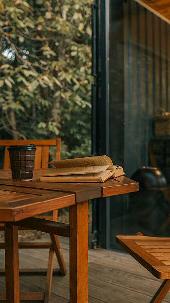 istock Cozy outdoor reading nook with coffee and a book 2242814275