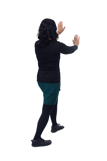 istock side back view of woman holding or squeezing a wall or something imaginary on white background 2242816718