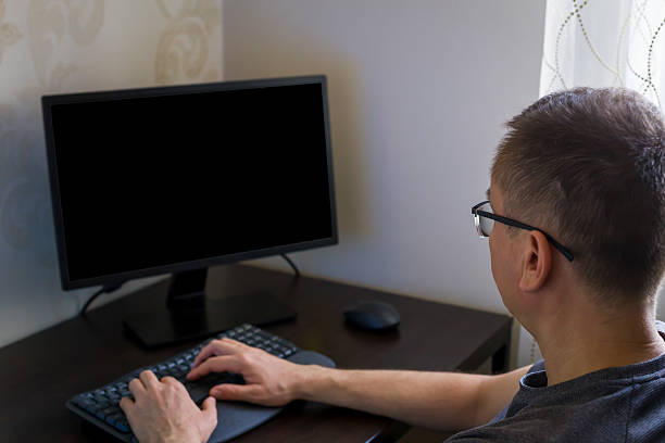 istock Man working at desk with computer and keyboard in cozy home office environment 2242818525