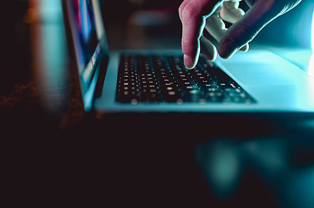istock Typing on laptop keyboard at night, cyber security concept 2242820346