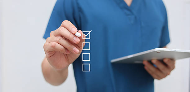 istock close up young general practitioner hand use stylus pen to check box on medical checklist or opd record to read and diagnose and assess about patient's symptom for healthy and lifestyle concept 2242820368
