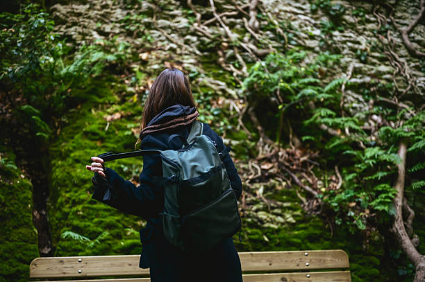 istock Woman with backpack exploring green forest nature 2242822942