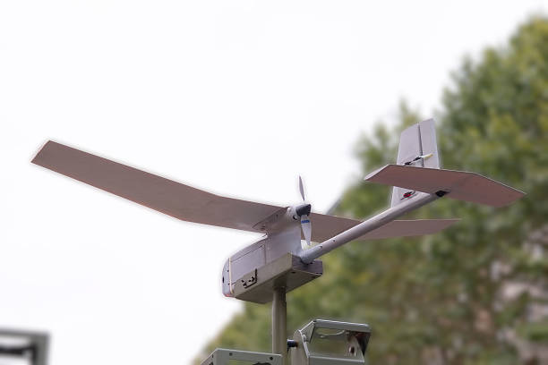 istock Drone with extended wings is ready for flight near green trees on a calm day 2242826006