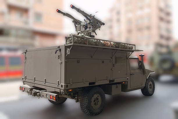 A military vehicle is positioned in an urban setting, displaying a mounted missile launch system. This scene captures military readiness amidst city architecture in daylight.