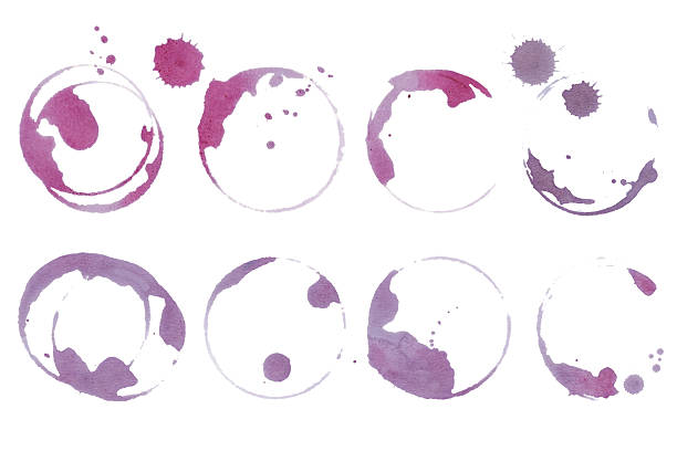 istock Real wine stains and glass ring marks on white background. Red vine glass stains set. Artistic grape juice spill texture for food and drink design 2242834388