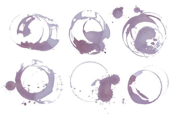 istock Wine stains and glass ring marks on white background. Real Red vine glass stains set. Artistic grape juice spill texture for food and drink design 2242834484