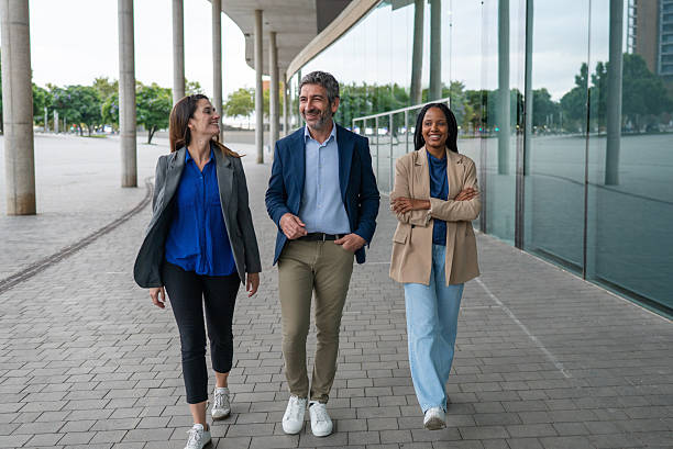 istock Diverse business team walking and smiling outdoors 2242836733