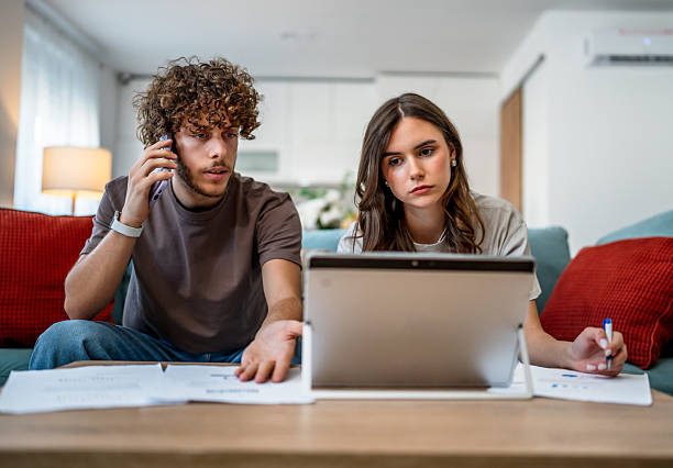 istock Young couple managing finances and bills at home 2242837159