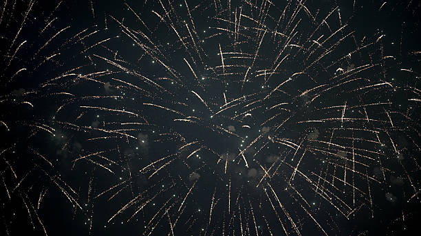 istock A glowing fireworks burst in a clear night sky with elegant spark trails. 2242839978