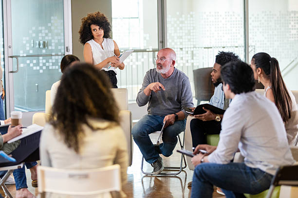istock Diverse group engaged in thoughtful discussion in a collaborative meeting or therapy session. 2242840134