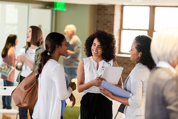 istock Diverse group of women networking and discussing ideas in an office setting. 2242840170