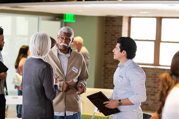 istock Diverse group of adults engaging in a conversation during a meeting 2242840178
