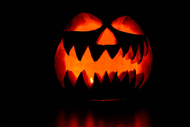 istock Spooky halloween pumpkin on a black background 2242844031